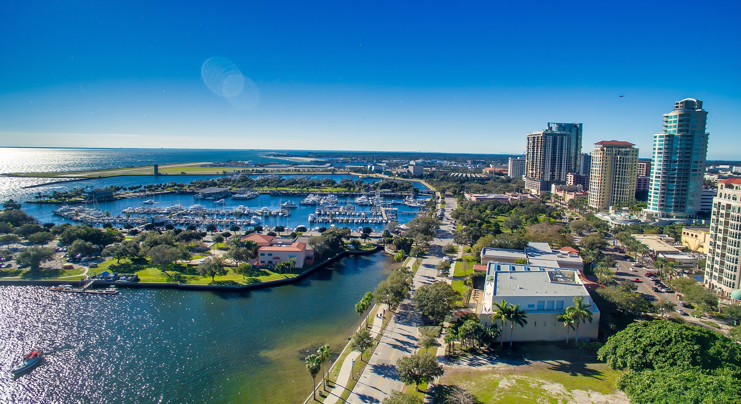 Aerial view of marina and city skyline.